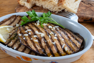 Italian style starter served in restaurant, grilled eggplant with garlic, olive oil and fresh parsley