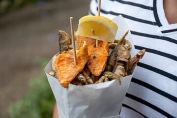 Italian streetfood, variety of catch of the day fish deep fried in paper cone