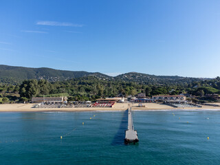 Obraz premium Aerial view on boats, crystal clear blue water of Plage du Debarquement white sandy beach near Cavalaire-sur-Mer and La Croix-Valmer, summer vacation on French Riviera, Var, France