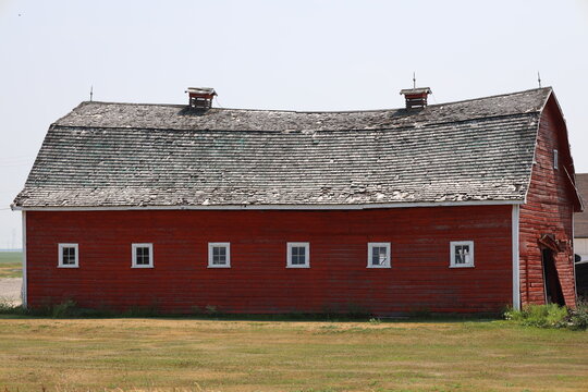 classic rural red barn sagging into the past