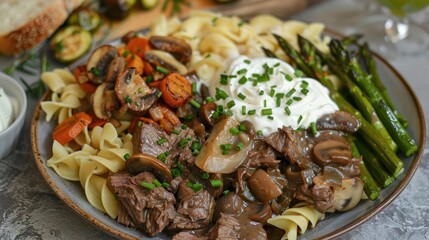 Tender beef tips with mushrooms and onions over egg noodles, sour cream, chives, roasted asparagus, roasted carrots, garlic bread, roasted Brussels sprouts, and a side of roasted zucchini