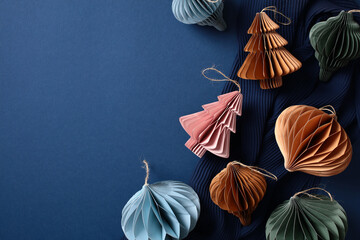 Honeycomb Christmas decorations on pastel blue background. Nordic, Scandinavian style Xmas ornaments. Flat lay, top view