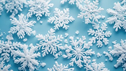 A cluster of beautiful snowflakes rests gently on a soft blue background, showcasing their unique and intricate designs that capture the essence of winter beauty