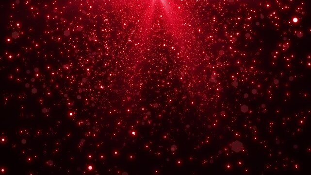 Falling red glitter particles background of red light.
