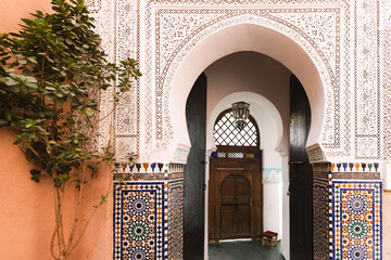 Entrance to Mosque, Intricate Moroccan Archway with Wooden Door and decorative colorful tiles, Marrakesh, Marrakech, Morocco