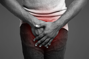 Erectile dysfunction concept. Close up of afro guy holding his crotch. Men's health