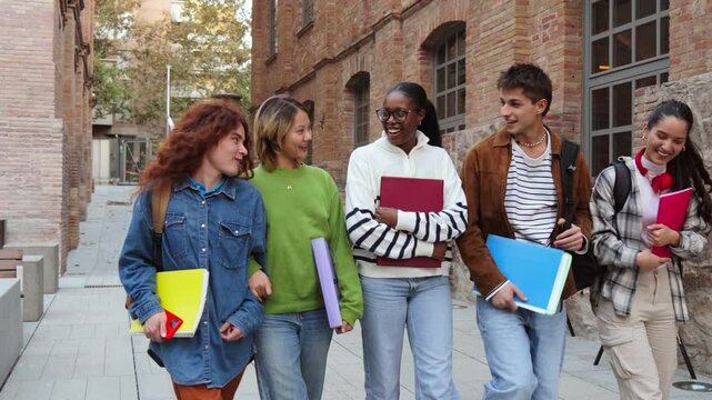 Group of diverse students walking together on campus, smiling and carrying notebooks, highlighting friendship, education, and student life in a university setting. Classmates enjoying school together