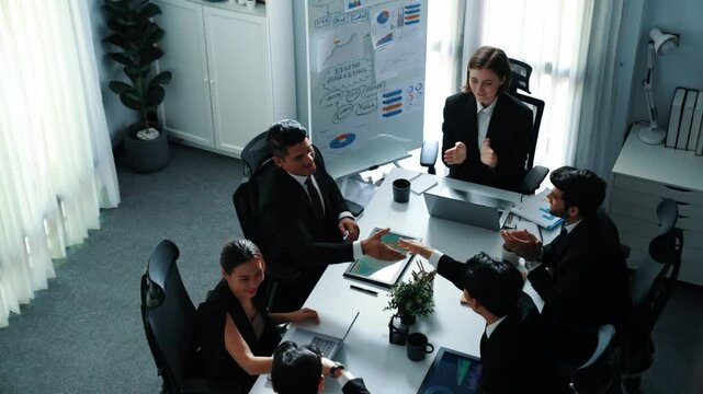 Top view of diverse team clapping hand and applause to celebrate for increasing sales at meeting room. Successful team shaking hand to congratulate successful project at meeting table. Directorate.