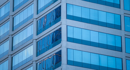 Fototapeta premium Abstract Background of a White Building Corner Wall with Blue Reflective Windows.