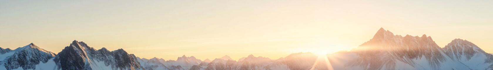 A highly detailed panorama of towering snow-capped mountains stretching across the horizon. The sharp ridges and crevices are vividly highlighted, with each rocky face clearly defined under the soft,