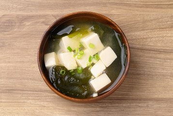 Miso soup with tofu, wakame seaweed and spring onion, Traditional Japanese soup, Table top view