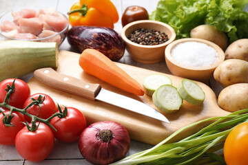 Uncooked ingredients for stew on tiled table, closeup
