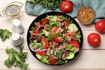 Delicious fresh tuna salad and ingredients on wooden table, top view