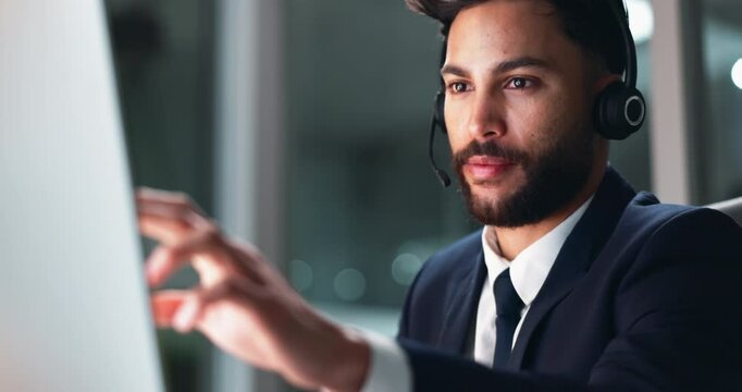 Call center, computer and solution with business man in office at night for technical support. Assistance, contact us or customer service and telemarketing employee talking with headset in workplace