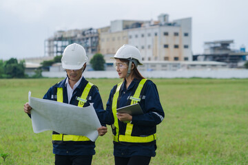 The engineering team surveyed the construction site. The engineering team worked outdoors next to the power plant.