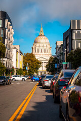 San Francisco City Hall shining through the clouds during rush hour traffic