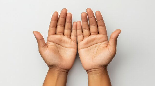Person holding both hands open against a plain background