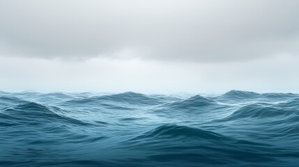 Vast ocean waves under cloudy sky with distant horizon in view