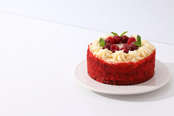 Red velvet cake with berries on white background, space for text