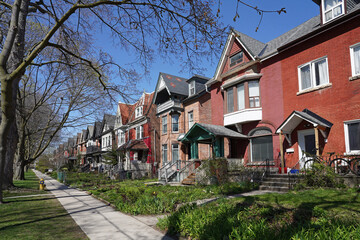 Residential street with long row of older houses with gables