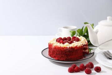 Red velvet cake, teapot, mint and berries on white background, space for text
