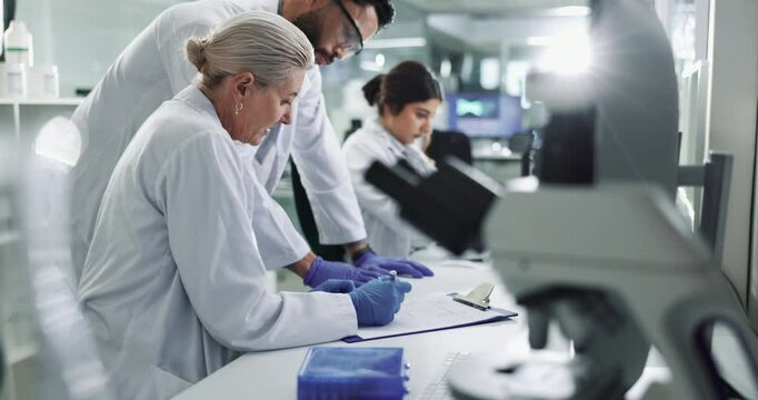 Clipboard, collaboration and science with team in lab for breakthrough, development or research. Desk, documents and innovation with people working together for pharmaceutical discovery or solution