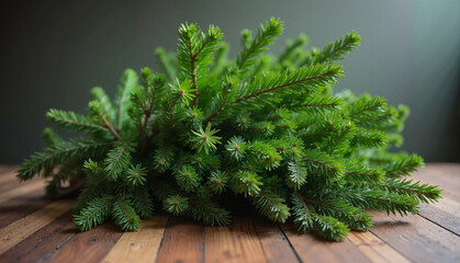 Fresh evergreen branches arranged beautifully on a wooden table for festive decoration and natural beauty
