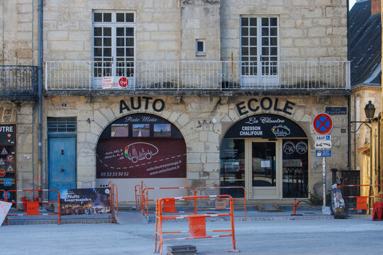 France, 16 August 2024: Auto Ecole driving school building facade under construction with road barriers.