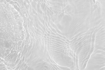 White water with ripples on the surface. Defocus blurred transparent white colored clear calm water surface texture with splashes and bubbles. Water waves with shining pattern texture background.
