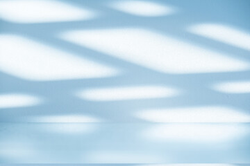 Studio style background wall decoration presentation uses white and blue tones. with shadows cast from a nearby window, concept creating a decorative backdrop.	