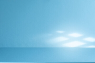 Studio style background wall decoration presentation uses white and blue tones. with shadows cast from a nearby window, concept creating a decorative backdrop.	