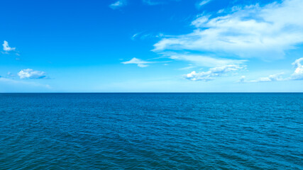Nature of the beach and sea Summer with sunshine, sandy beaches, clear blue waters sparkling against the blue sky. On an island with good ecology and environment Background for summer vacation concept