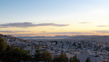 View of the Athens city and the port of Piraeus from a hill during dusk time. Nice dramatic sky.
