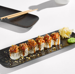 Stylized Burnt Salmon Sushi Rolls with Elegant Plate Presentation