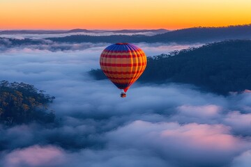 Obraz premium Hot Air Balloon Floating Above Clouds at Sunrise