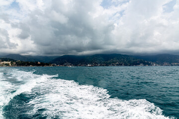 Small city near Portofino from the sea with dramatic sky