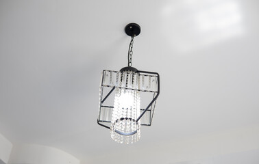 Crystal pendant ceiling light mounted on a white ceiling.