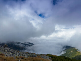 Early autumn scenery in the Transylvanian Alps with mist and storm clouds