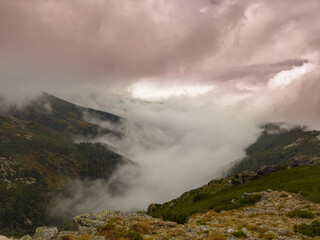 Early autumn scenery in the Transylvanian Alps with mist and storm clouds