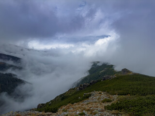 Early autumn scenery in the Transylvanian Alps with mist and storm clouds