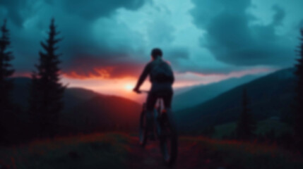 Obraz premium Blurred Silhouette of a Cyclist Riding Along a Mountain Trail at Dawn
