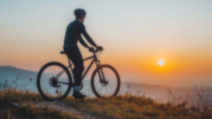 Obraz premium Cyclist's Silhouette Blurred on a Mountain Trail, Surrounded by the Warm Sunrise