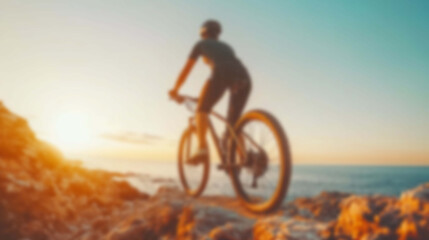 Obraz premium Blurred Silhouette of a Cyclist Ascending a Mountain Trail in the Sunrise Light