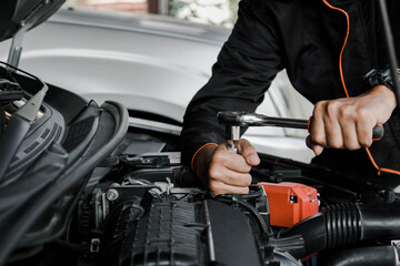 Mechanic fixing a car at home. Repair and service.