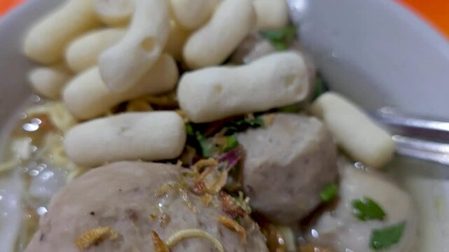 cooking and show of making bakso or meatballs, preparing bakso beef meatball, view of a bakso vendor preparing meatball dish for the buyer