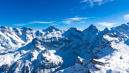 Obraz premium The banner mountain view of alpine as snow-capped mount peaks scene in Winter mountains background