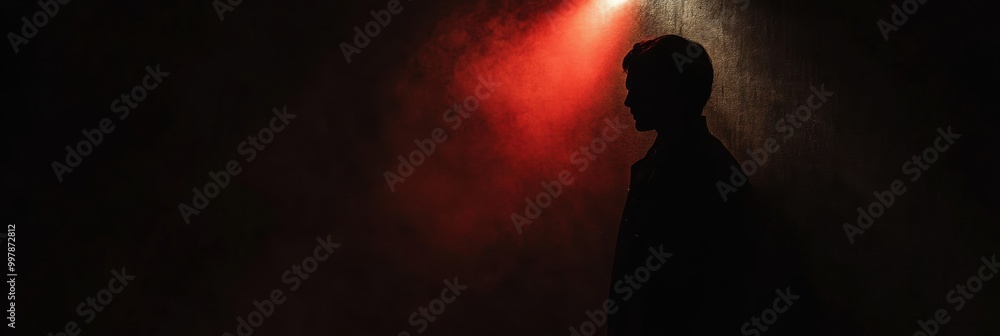 Poster in a dark room, a solitary spotlight reveals a shadowy figure, creating an atmosphere filled with su