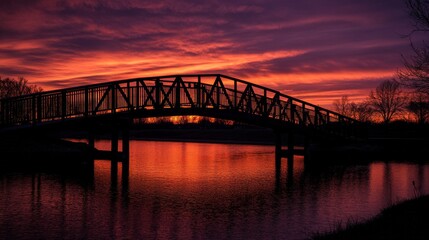 Obraz premium Bridge Silhouette at Sunset Over Water