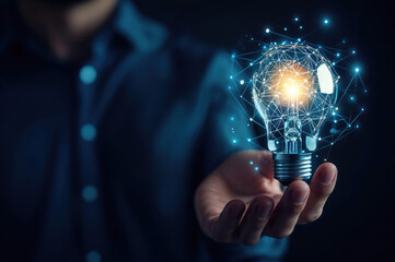 Businessman holding light bulb connected with network representing innovative idea