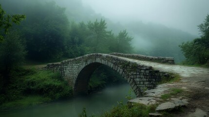 Fototapeta premium Stone Bridge in a Foggy Forest - Tranquil Rural Landscape